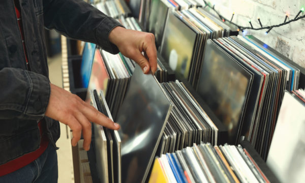 Man choosing vinyl records in store, closeup
